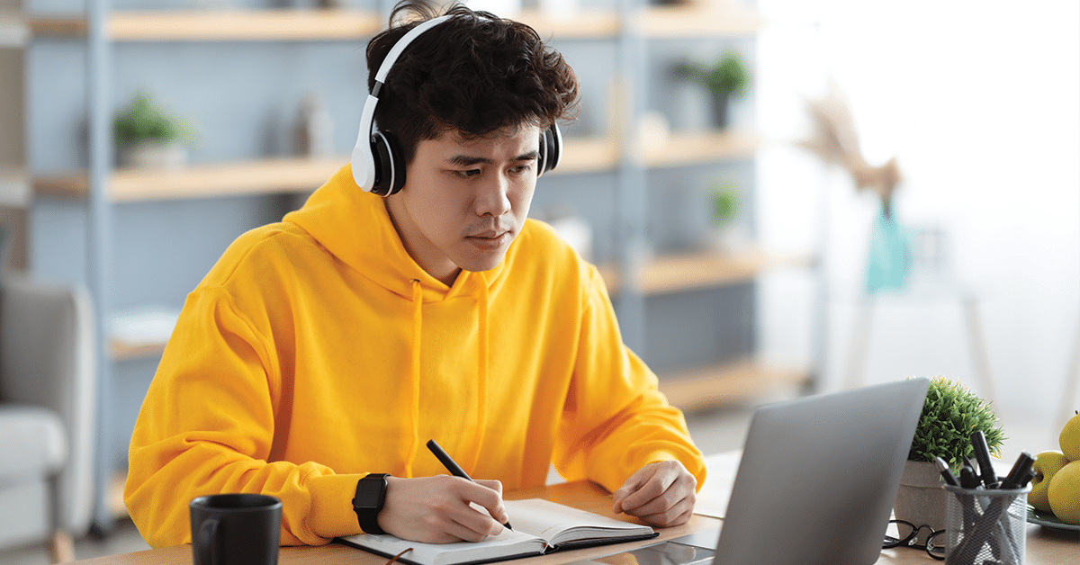focused asian man working on laptop and writing 2021 10 11 16 27 22 utc.jpg 1