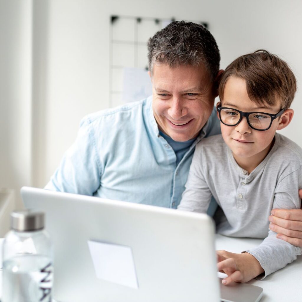 man and his son using a computer