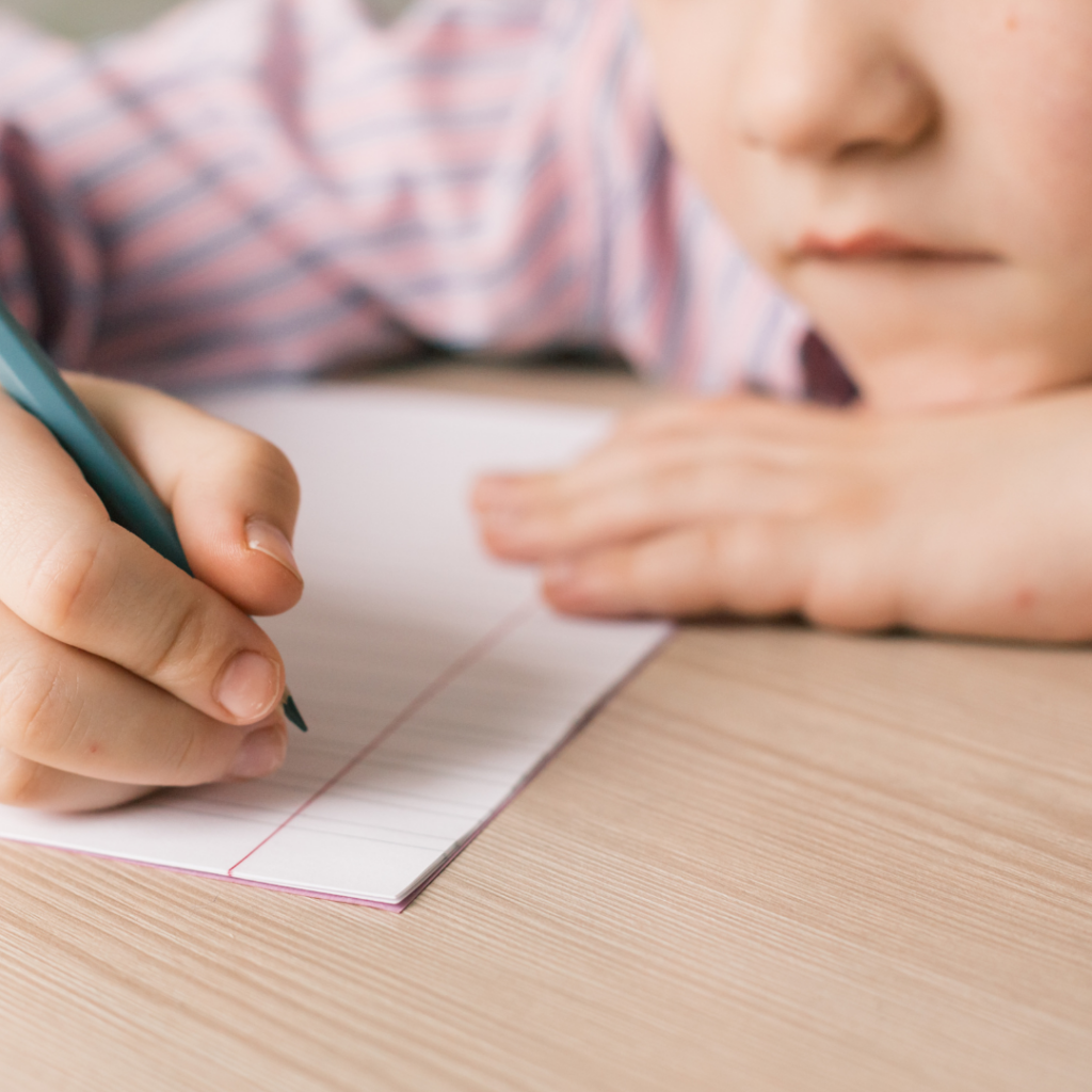 a boy about to write on a piece of paper