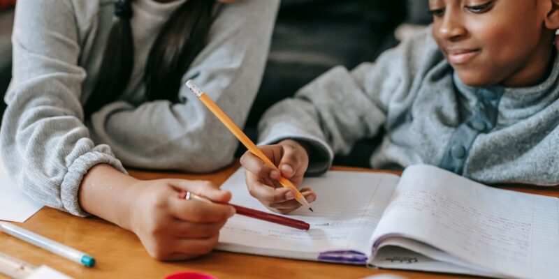 parent working with child on a writing lesson