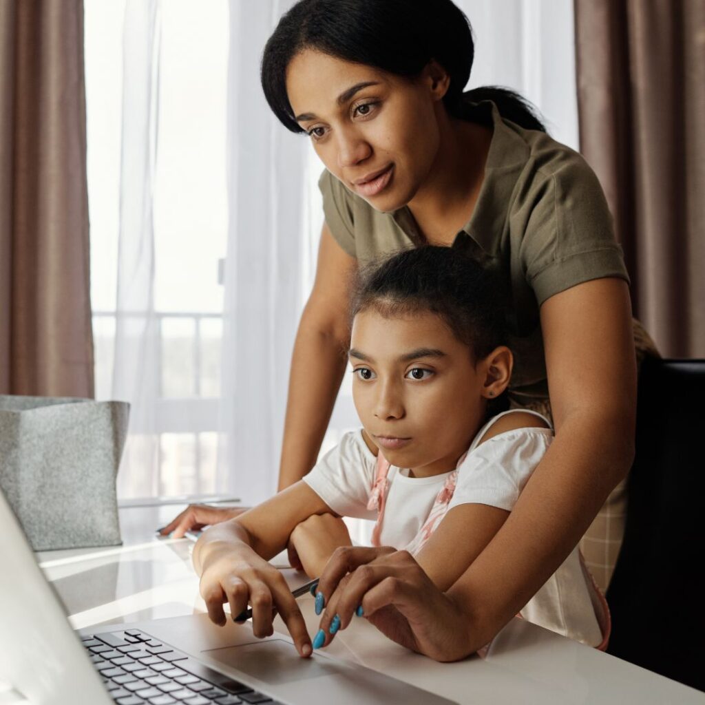 mom helping her child with a writing lesson