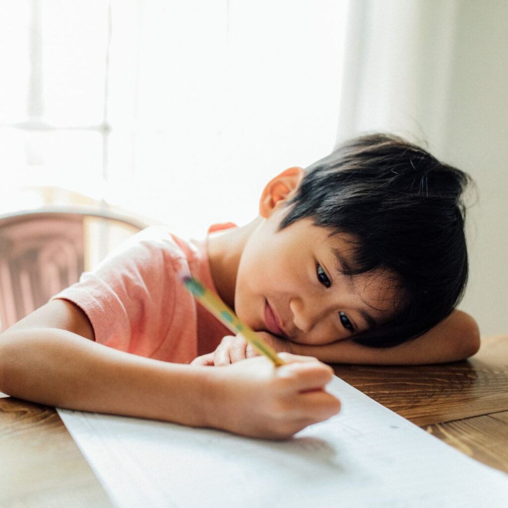 young boy writing