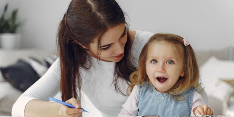 parent helping young student with writing